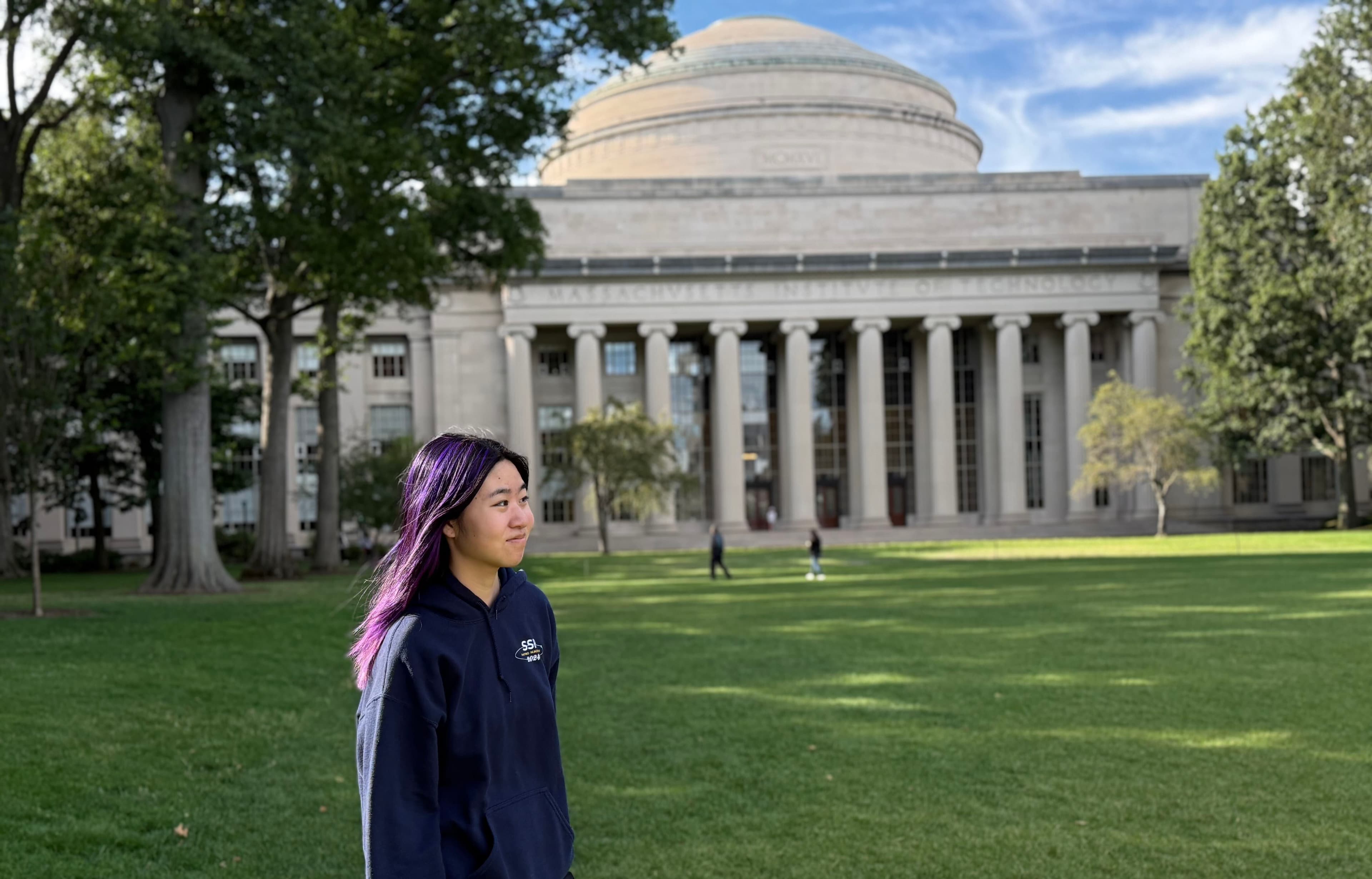 Michelle standing on Killian Court in front of MIT's Great Dome