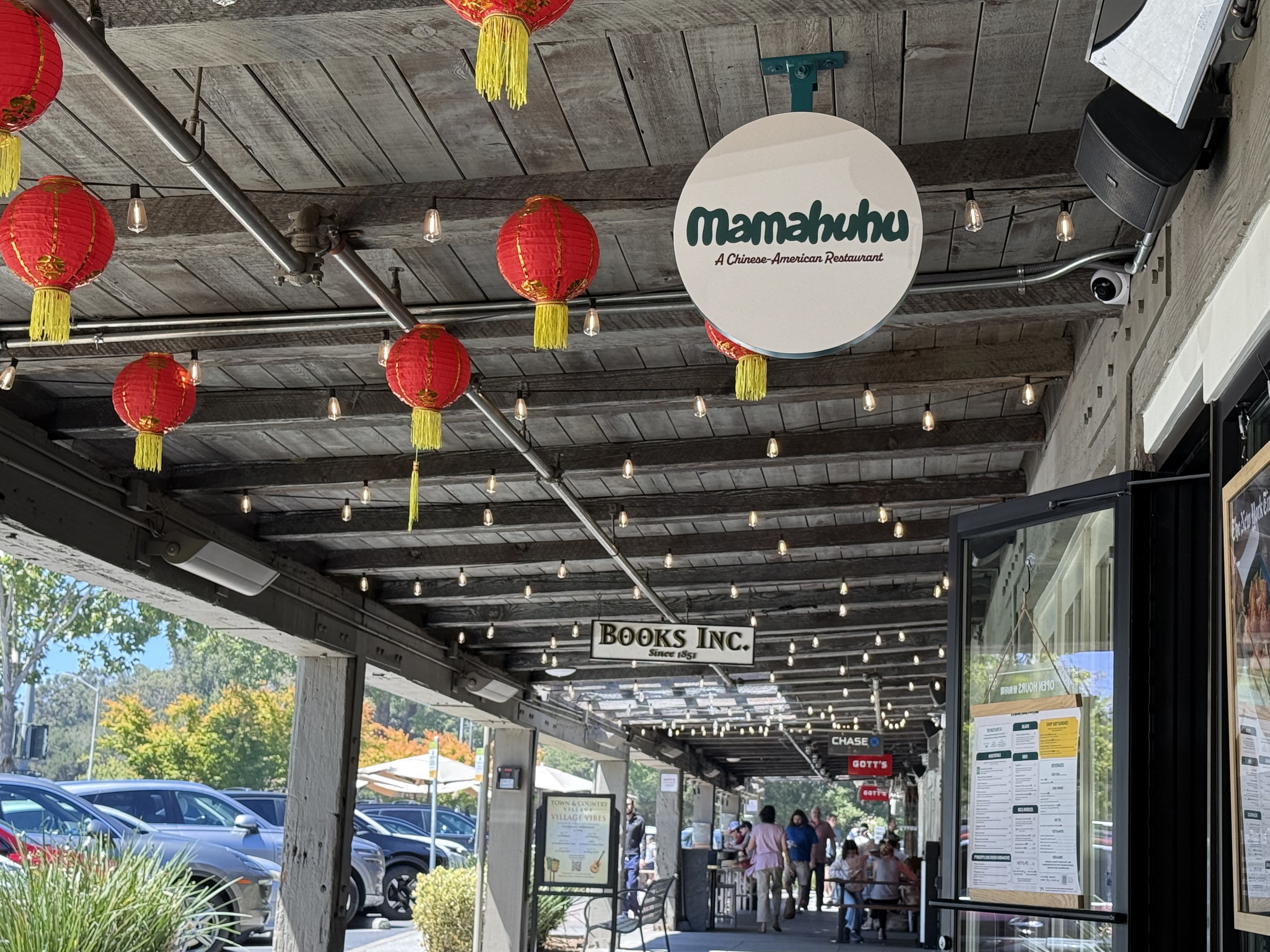 The storefront of Mamahuhu, a Chinese-American restaurant, with red paper lanterns strung under the awning